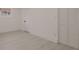 A vacant bedroom features light gray flooring, white walls and trim, and a bi-fold door closet at 5801 N 17Th St, Tampa, FL 33610