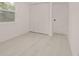 Vacant bedroom with light gray flooring, white walls, and natural light from the windows at 5801 N 17Th St, Tampa, FL 33610