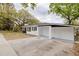 Charming home with a brick facade and white accents, complemented by a chimney and a well-manicured front lawn at 5801 N 17Th St, Tampa, FL 33610