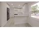 Bright kitchen featuring stainless steel appliances, white cabinets, breakfast bar and light colored floors at 5801 N 17Th St, Tampa, FL 33610