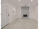 View of the living room with a modern fireplace, decorative front door, and beautiful light colored floors at 5801 N 17Th St, Tampa, FL 33610