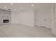 A modern living room featuring a stone fireplace and sleek wood flooring at 5801 N 17Th St, Tampa, FL 33610