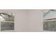 This vacant room has white walls and two windows with views to the outside at 5801 N 17Th St, Tampa, FL 33610