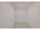 An empty walk-in closet features wire shelving and light wood-look laminate flooring at 5801 N 17Th St, Tampa, FL 33610