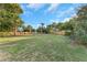 Expansive backyard with a wooden fence, mature trees, and lush green grass at 605 Citrus Ct, Largo, FL 33770