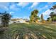 Spacious backyard with a brick patio and mature trees at 605 Citrus Ct, Largo, FL 33770
