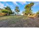 Large backyard with mature trees and a privacy fence at 605 Citrus Ct, Largo, FL 33770