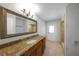 Bathroom vanity features granite counters, a large framed mirror, and recessed lighting at 605 Citrus Ct, Largo, FL 33770