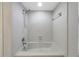 A bathroom featuring a bathtub shower combination with white tile and neutral walls at 605 Citrus Ct, Largo, FL 33770