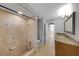 The bathroom features a large stone-tiled shower, toilet, vanity and large mirror at 605 Citrus Ct, Largo, FL 33770