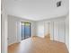 Bright bedroom with wood-look floors, sliding glass door and patio at 605 Citrus Ct, Largo, FL 33770