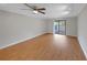 Bright bedroom with wood flooring and sliding glass door to the outside at 605 Citrus Ct, Largo, FL 33770