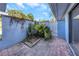 Private courtyard with brick pavers and lush tropical plants at 605 Citrus Ct, Largo, FL 33770