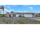 Charming single-story home with a two-car garage, tile roof, and low-maintenance landscaping at 605 Citrus Ct, Largo, FL 33770