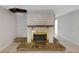 View of brick fireplace with wooden mantel and brick platform at 605 Citrus Ct, Largo, FL 33770