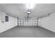 Spacious two-car garage with gray painted floor, white walls, and a metal sectional door at 605 Citrus Ct, Largo, FL 33770