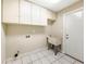 The laundry room features built-in cabinets, tile floors, and a utility sink at 605 Citrus Ct, Largo, FL 33770