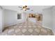 View of open living area with tile flooring and kitchen beyond at 605 Citrus Ct, Largo, FL 33770