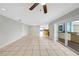View of large living area with tile flooring, patio access, and kitchen in the distance at 605 Citrus Ct, Largo, FL 33770