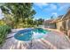 Enjoy a refreshing dip in this private backyard pool with brick pavers and lush landscaping at 605 Citrus Ct, Largo, FL 33770