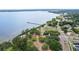 Scenic aerial view featuring a waterfront park with lush greenery, playground, pier and bay views at 611 Shore E Dr, Oldsmar, FL 34677