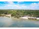Overhead shot capturing a serene beach with green foliage and a scenic lake at 611 Shore E Dr, Oldsmar, FL 34677