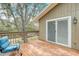 Back deck with sliding glass doors and views of the lush, green backyard at 611 Shore E Dr, Oldsmar, FL 34677