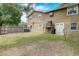Spacious backyard featuring a lawn, wood fence, hammock and access to home entrance at 611 Shore E Dr, Oldsmar, FL 34677