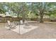 Paver patio with fire pit surrounded by seating in a fenced backyard at 611 Shore E Dr, Oldsmar, FL 34677