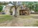 Expansive backyard with a large deck, mature trees, and a charming hammock at 611 Shore E Dr, Oldsmar, FL 34677