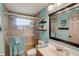Bathroom featuring a tiled glass shower, and a modern vanity with a large mirror and great lighting at 611 Shore E Dr, Oldsmar, FL 34677