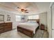 Bedroom features wood tray ceiling with ceiling fan, carpet and wooden dresser at 611 Shore E Dr, Oldsmar, FL 34677
