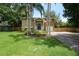 Charming two-story home with front lawn, an American flag and easy access to the garage at 611 Shore E Dr, Oldsmar, FL 34677