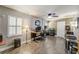 Spacious home office with a ceiling fan, tile floors, and rustic wood paneled wall at 611 Shore E Dr, Oldsmar, FL 34677