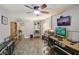 A home office featuring dual monitors, tile floors, and natural light from a window at 611 Shore E Dr, Oldsmar, FL 34677