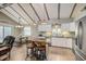 Bright kitchen with a center island, white cabinets, stainless appliances, and modern lighting at 611 Shore E Dr, Oldsmar, FL 34677