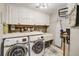 Well-organized laundry room featuring a front load washer and dryer and ample storage cabinets at 611 Shore E Dr, Oldsmar, FL 34677