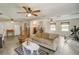 Spacious living room featuring tile flooring, multiple ceiling fans and bright natural light at 611 Shore E Dr, Oldsmar, FL 34677