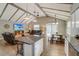 Inviting living area with vaulted ceilings, wooden beams, an open floor plan, and natural light at 611 Shore E Dr, Oldsmar, FL 34677