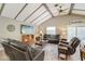 Bright living room with vaulted ceilings, wood beams, and comfortable leather seating at 611 Shore E Dr, Oldsmar, FL 34677