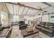 Open-concept living area featuring wood beams, a sliding barn door, and modern decor at 611 Shore E Dr, Oldsmar, FL 34677