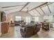 Spacious living room with vaulted ceilings, wooden beams, and contemporary furnishings at 611 Shore E Dr, Oldsmar, FL 34677