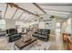 Stylish living area with a vaulted ceiling, wooden beams, and an open layout at 611 Shore E Dr, Oldsmar, FL 34677