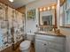 Well-lit bathroom featuring tiled shower, granite countertop vanity, and tropical-themed decor at 6202 7Th S Ave, Gulfport, FL 33707