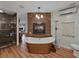 Bright bathroom featuring a copper soaking tub, stone accent wall, and modern fixtures at 6202 7Th S Ave, Gulfport, FL 33707
