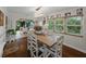 Dining room features rustic table, natural light, and direct access to the open kitchen at 6202 7Th S Ave, Gulfport, FL 33707