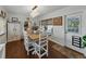 Light-filled dining room with a rustic wood table, decorative chandelier and decor at 6202 7Th S Ave, Gulfport, FL 33707
