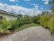 Paver driveway adorned with lush greenery, guiding to a charming home on a sunny day at 6202 7Th S Ave, Gulfport, FL 33707