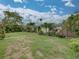 Spacious lawn with mature trees and landscaping enhance the home's curb appeal at 6202 7Th S Ave, Gulfport, FL 33707
