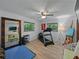 Bright home gym equipped with a treadmill, weights, and mirror, perfect for fitness enthusiasts at 6202 7Th S Ave, Gulfport, FL 33707